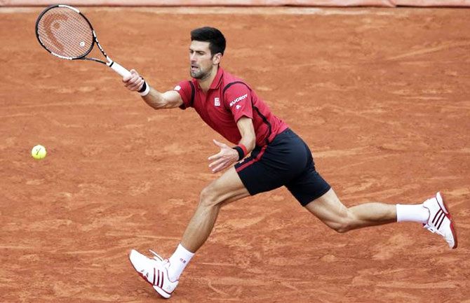 Novak Djokovic plays a return against Dominic Thiem during their French Open semi-final on Friday