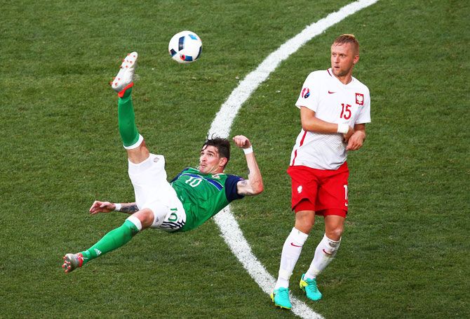 Northern Ireland's Kyle Lafferty attempts an overhead kick as a Polish player watches during their Euro 2016 Group C match at Allianz Riviera Stadium in Nice, on Sunday, June 12