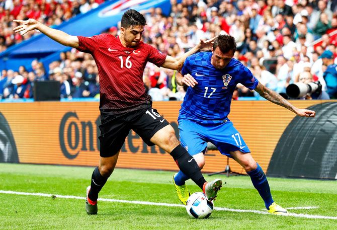 Turkey's Ozan Tufan and Croatia's Mario Mandzukic vie for possession during their Euro 2016 match on Sunday