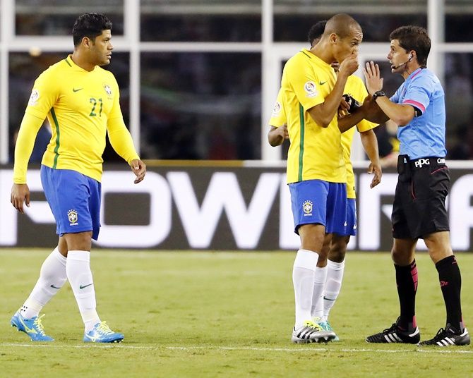 Brazil defender Miranda, centre, talks with referee Andres Cunha after he allowed the only goal of the game