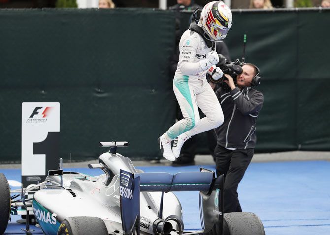 Great Britain and Mercedes' Lewis Hamilton jumps off his car after winning the Canadian Formula One Grand Prix at Circuit Gilles Villeneuve in Montreal, Canada, on Sunday