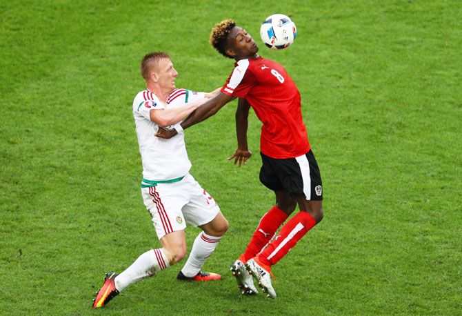  Austria's David Alaba controls the ball under pressure from Hungary's Laszlo Kleinheisler during their match on Tuesday