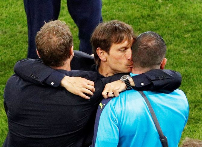 Italy head coach Antonio Conte can’t hide his excitement as celebrates with team officials after his team’s victory over Belgium in their Group E match in Lyon on Monday, June 13.