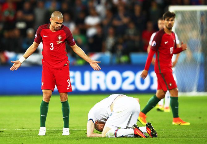 Portugal's Pepe puts on an innocent face after colliding with Iceland's Jon Dadi Bodvarsson