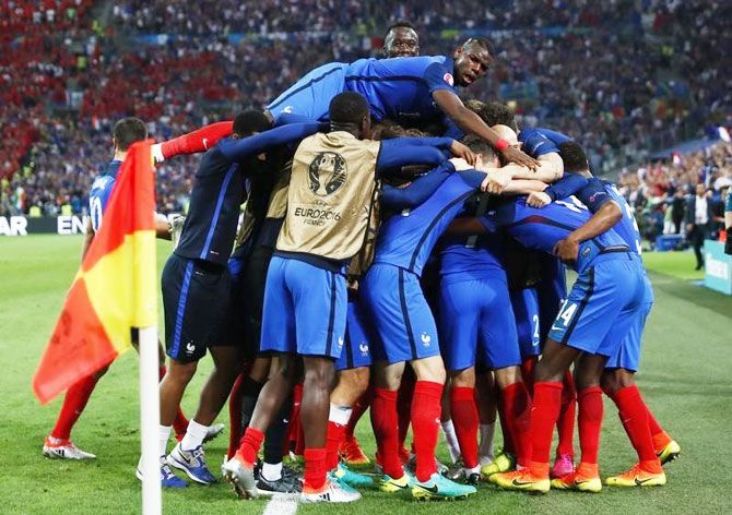 France's Antoine Griezmann is mobbed by teammates after scoring their first goal against Albania during their Euro 2016 Group A match at Stade Velodrome, in Marseille on Wednesday
