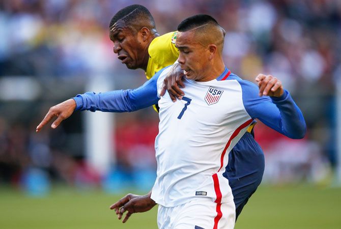 United States' Bobby Wood battles for the ball with Ecuador's Frickson Erazo (left)