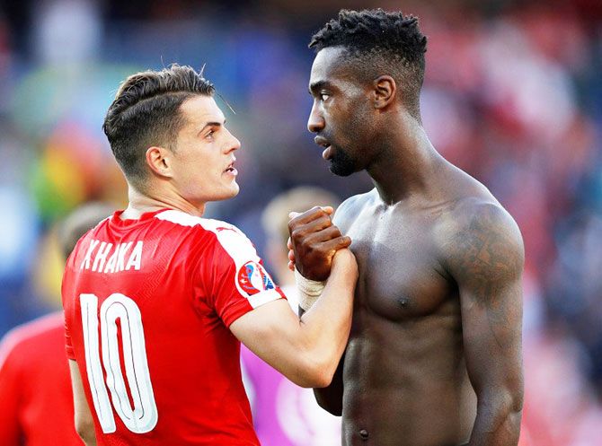 Switzerland's Granit Xhaka and Johan Djourou at the end of the game against Romania