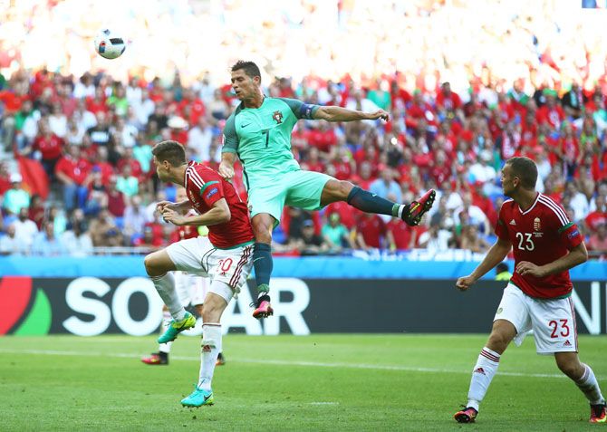 Portugal's Cristiano Ronaldo and Hungary's Richard Guzmics in an aerial duel during their Euro 2016 Group F match at Stade des Lumieres in Lyon on Wednesday