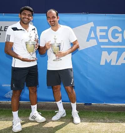: India’s Purav Raja, left, and Divij Sharan pose with the trophy after winning the doubles title at the Aegon Manchester tournament