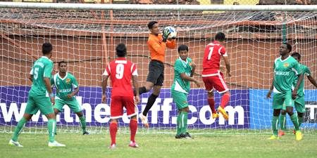 Salgaocar players, in green, defend during a match against Shillong Lajong