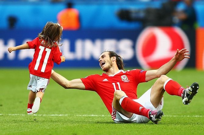 Wales player Gareth Bale celebrates with daughter Aba Violet after the victory against Northern Ireland