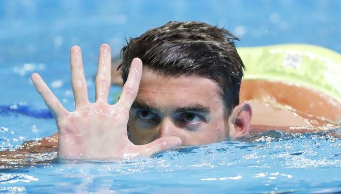 Michael Phelps holds up five fingers in celebration during the finals for the men's 200 meter butterfly in the US Olympic swimming team trials at CenturyLink Center on Wednesday