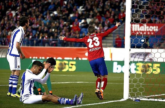 Atletico Madrid's Luciano Vietto (right) celebrates after beating Real Sociedad defenders to score the second goal during their La Liga match at Vicente Calderon stadium in Madrid on Tuesday