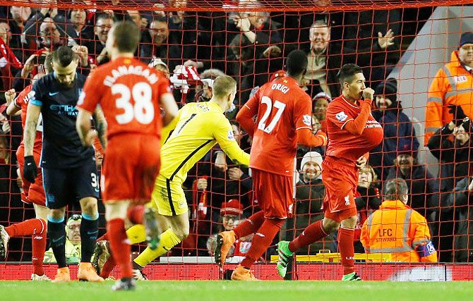Liverpool's Roberto Firmino celebrates after scoring their third goal against Manchester City at Anfield