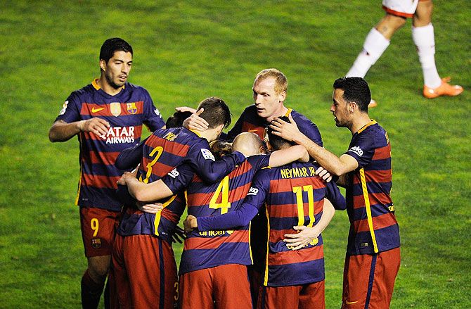 FC Barcelona players celebrate a goal by teammate Ivan Rakitic during their La Liga match against Rayo Vallecano at Estadio de Vallecas in Madrid on Thursday