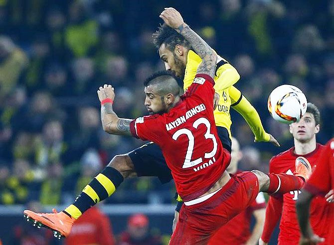 Bayern Munich's Arturo Vidal and Borussia Dortmund's Pierre-Emerick Aubameyang are involved in a challenge