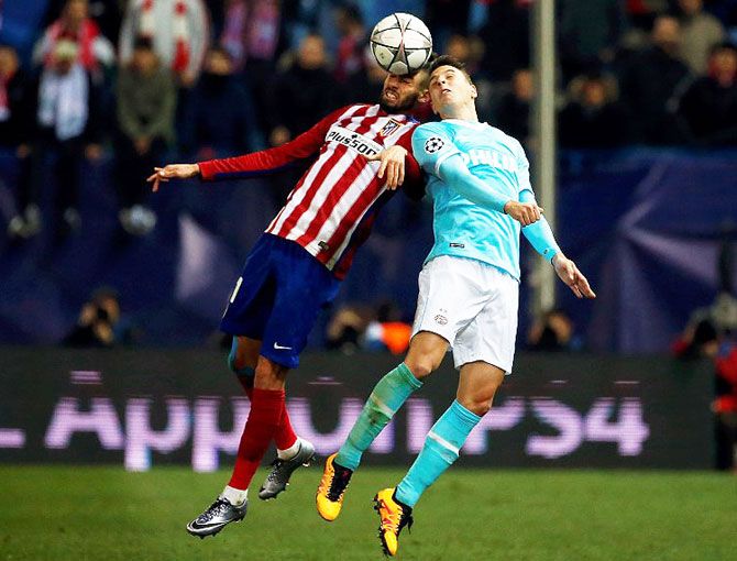 Atletico Madrid's Yannick Ferreira-Carrasco and PSV Eindhoven's Marco van Ginkel locked in an aerial duel
