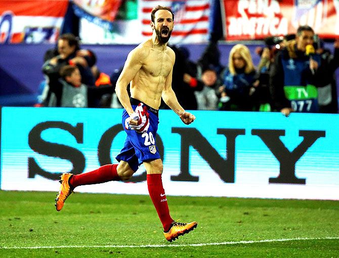 Atletico Madrid's JuanFran Torres celebrates after scoring the winning goal off a penalty shootout after extra time during their UEFA Champions League Round of 16 Second Leg match against PSV Eindhoven at Vicente Calderon stadium, in Madrid on Tuesday
