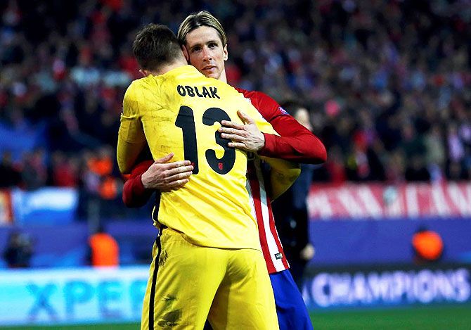 Atletico Madrid's Fernando Torres embraces Atletico Madrid's goalkeeper Jan Oblak