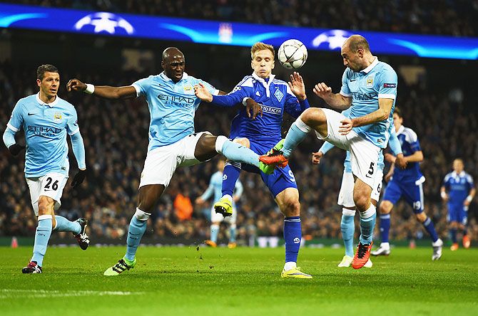 Manchester City's Eliaquim Mangala and Pablo Zabaleta challenge Dynamo Kiev's Mykola Morozyuk