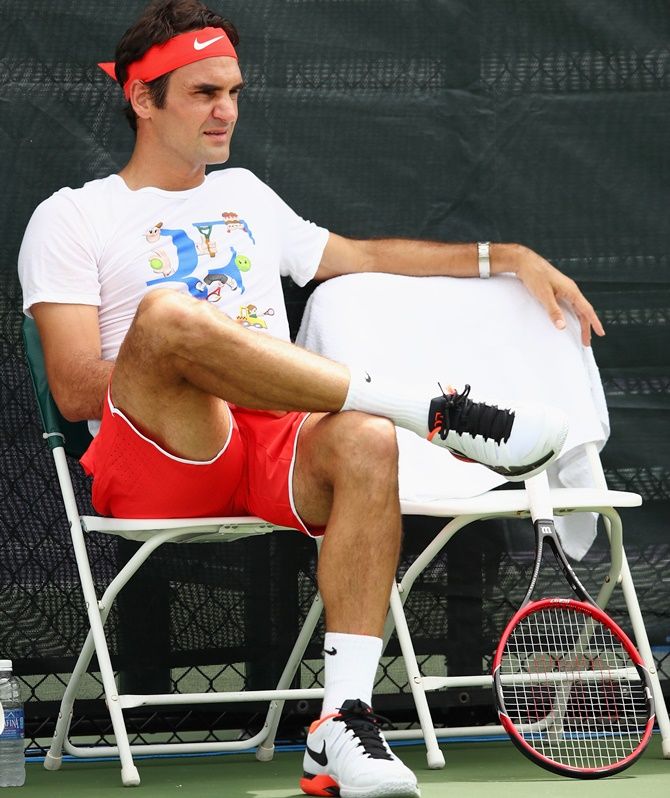 Switzerland's Roger Federer takes a break during a practice session