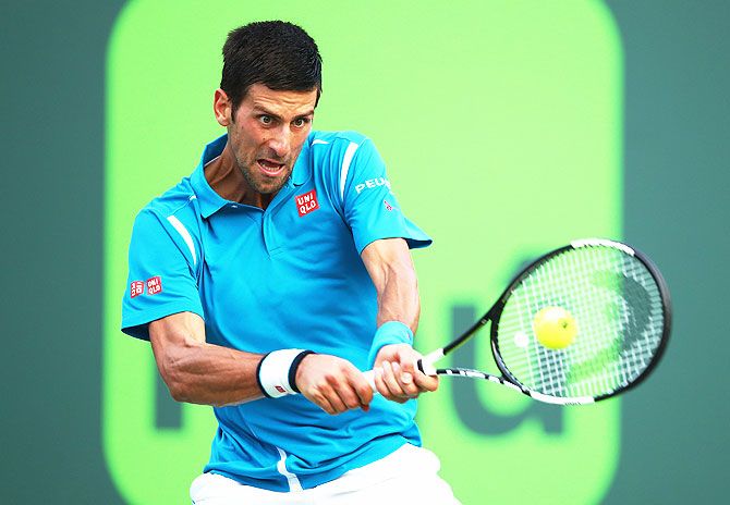 Serbia's Novak Djokovic plays a backhand against Portugal's Joao Sousa in their third round match at the Miami Open at Crandon Park Tennis Center in Key Biscayne, Florida, on Sunday
