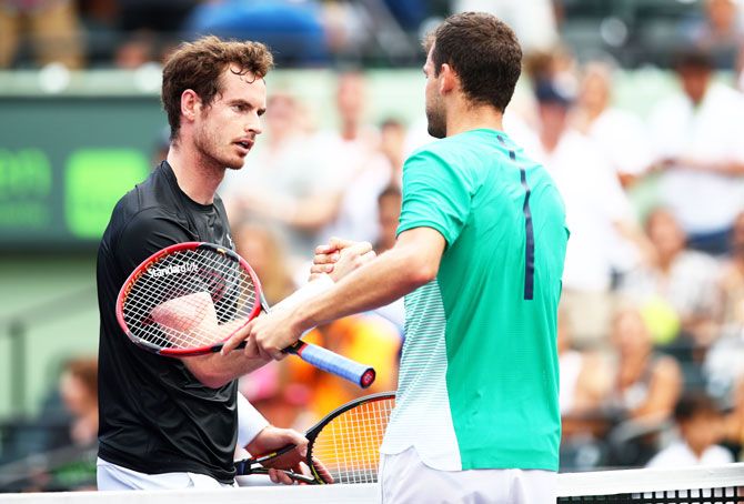 Grigor Dimitrov shakes hands at the net after his three set victory against Andy Murray in their third round match at the Miami Open on Monday