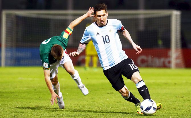Argentina's Lionel Messi outruns a Bolivia player