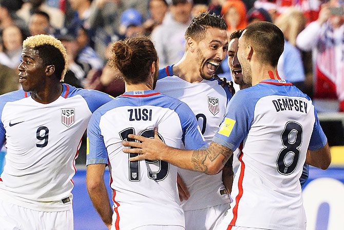 USA's Geoff Cameron celebrates his goal with teammates Graham Zusi #19 and Clint Dempsey #8 during their FIFA 2018 World Cup qualifier against Guatemala at MAPFRE Stadium in Columbus, Ohio, on Tuesday