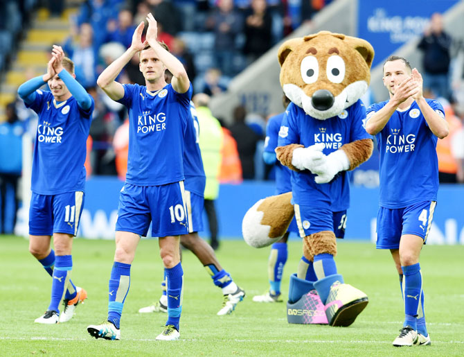 Leicester City players celebrate at the end of a Barclays Premier League match against Swansea City at the King Power Stadium on April 24