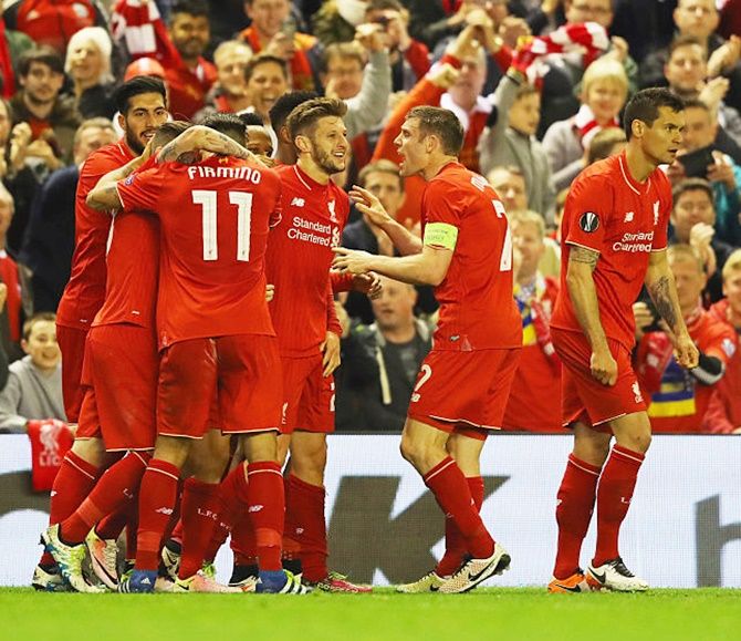 Adam Lallana of Liverpool (third right), celebrates with teammates and fans