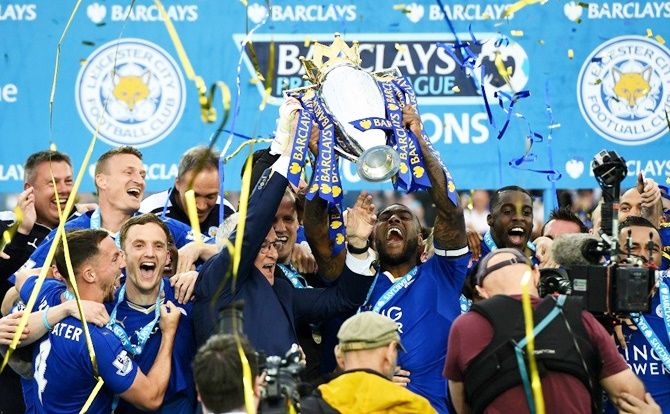 Leicester City players celebrate with the EPL trophy