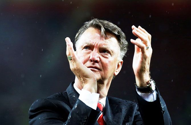 Manchester United manager Louis van Gaal applauds fans during a lap of honour on Tuesday