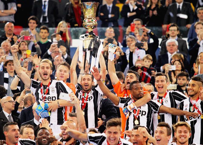 Juventus FC captain Giorgio Chiellini (centre) celebrates with his teammates after winning the TIM Cup final against AC Milan at Stadio Olimpico in Rome, on Saturday