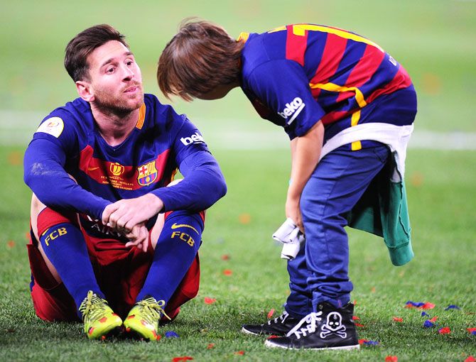 Lionel Messi speaks to a kid after the win
