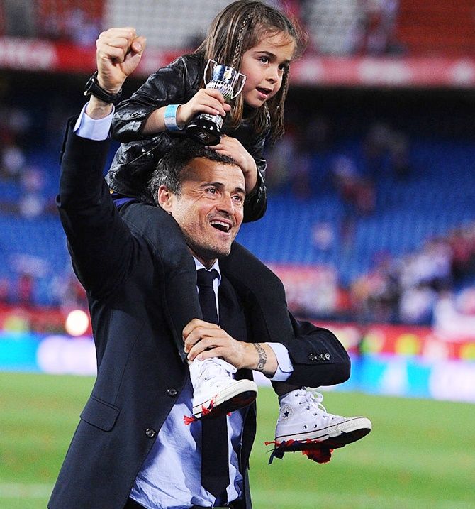 FC Barcelona's head coach Luis Enrique celebrates with his daughter Xana