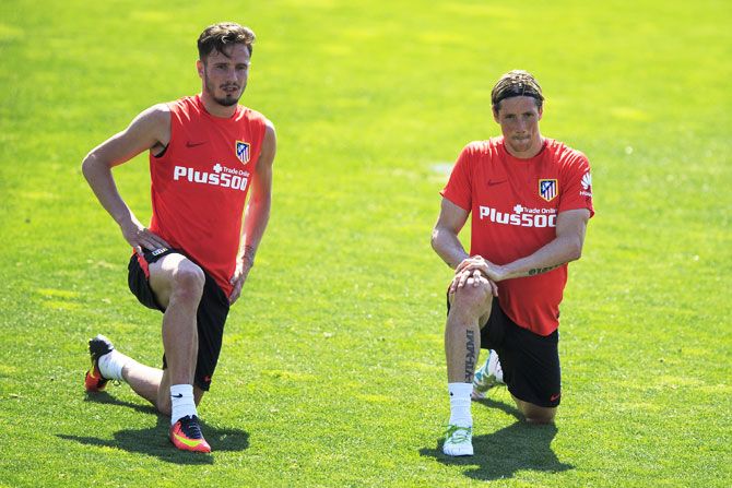Atletico de Madrid players Saul Niguez (left) and Fernando Torres stretch during a training session in Majadahonda, Spain