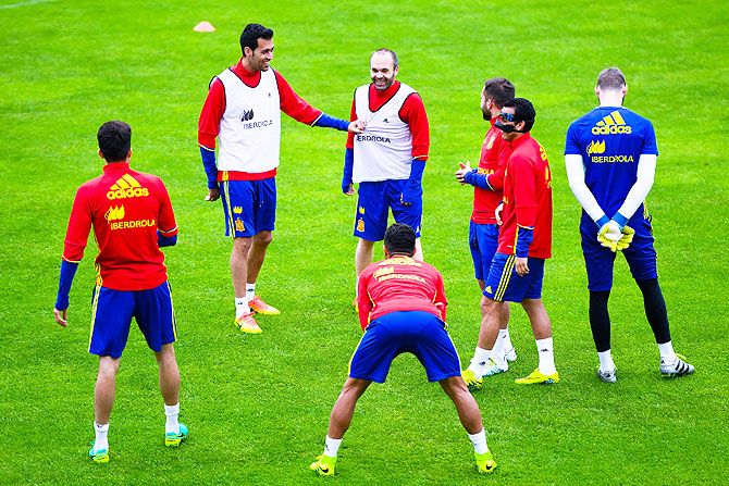 Spain's Sergio Busquets (left) and Andres Iniesta, Jordi Alba, Pedro Rodrigues and others share a joke during a training session in Schruns, Austria, on Monday