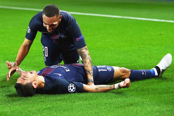 PSG's Angel Di Maria celebrates scoring his team's first goal with team mate Layvin Kurzawa during their UEFA Champions League Group A match between against Fussball Club Basel 1893 at Parc des Princes in Paris on Tuesday