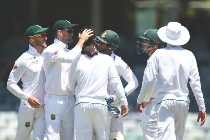 South Africa's Jean-Paul Duminy gets a kiss from 'keeper Quinton de Kock after dismissing Australia's Usman Khawaja in the first Test at the WACA in Perth