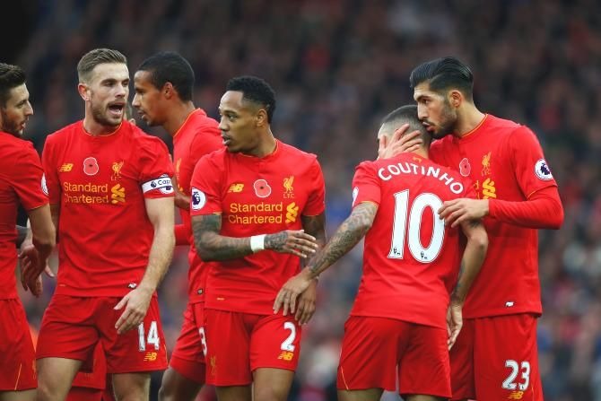 Liverpool's Philippe Coutinho celebrates with teammates after scoring his side's second goal against Watford during their Premier League match at Anfield in Liverpool on Sunday