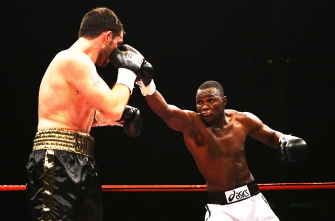 Francis Cheka (right) throws a punch