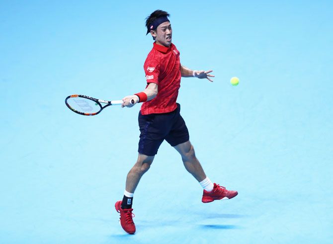 Japan's Kei Nishikori plays a forehand during the men's singles match against Switzerland's Stan Wawrinka on day two of the ATP World Tour Finals at the O2 Arena in London on Monday