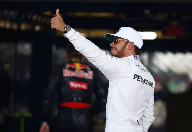 Lewis Hamilton of Great Britain and Mercedes GP waves to the crowd in parc ferme 