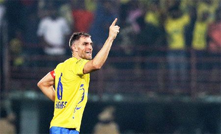 Kerala Blasters' Aaron Hughes celebrates after scoring against Pune City FC on Friday