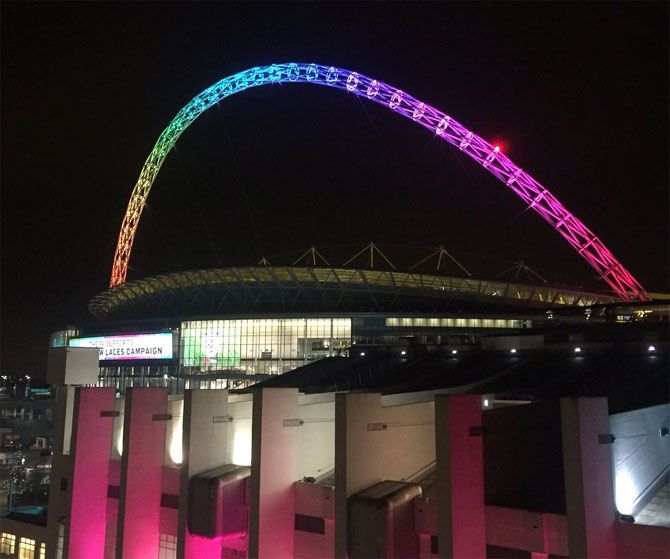 Wembley Stadium lit up in colours of the rainbow