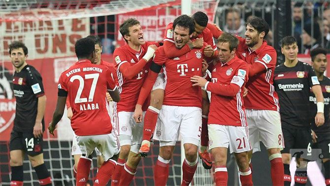Bayern Munich players celebrate a goal against Bayer Leverkusen during their Bundesliga match on Sunday