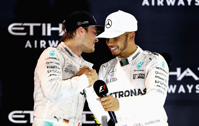 Race winner Lewis Hamilton congratulates second place finisher and World Champion Nico Rosberg of Germany on the podium