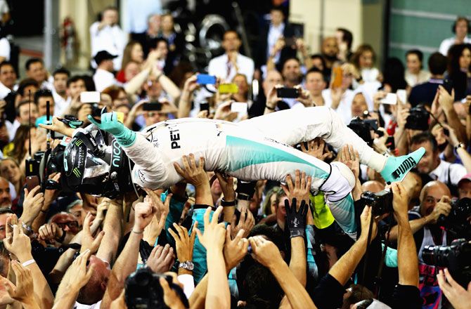 Nico Rosberg of Germany and Mercedes GP celebrates after finishing second and winning the F1 World Drivers Championship during the Abu Dhabi Formula One Grand Prix at Yas Marina Circuit in Abu Dhabi, United Arab Emirates, on Sunday