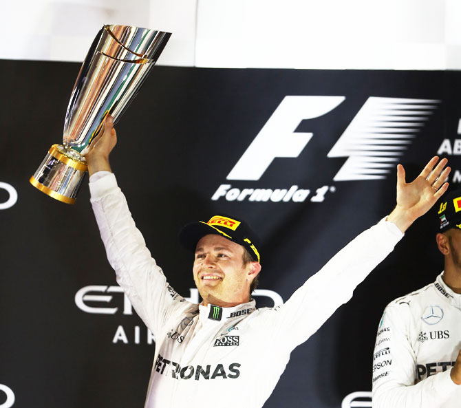 Germany and Mercedes GP's Nico Rosberg celebrates after finishing second on the podium and winning the F1 World Drivers Championship during the Abu Dhabi Formula One Grand Prix at Yas Marina Circuit in Abu Dhabi on Sunday